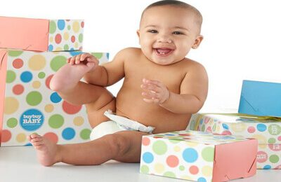 laughing baby next to presents