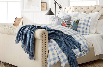 bed with linens and blanket