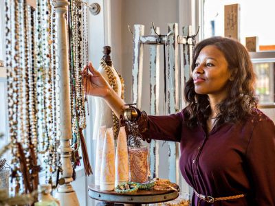 Woman admiring necklaces in a downtown Alpharetta shop