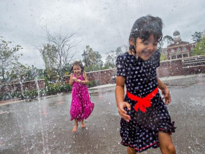 little girls playing in a large outdoor splash fountain in Alpharetta GA