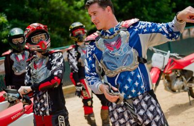 group of riders in motocross gear having a discussion