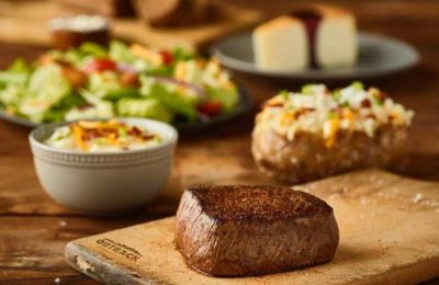 a steak, baked potato, soup and salad at Outback Steakhouse