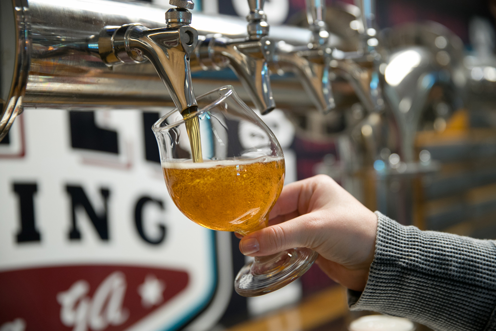 pouring a light beer from tap at Jekyll Brewing