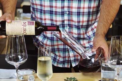 pouring wine into a decanter