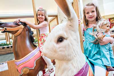girls riding on a carousel
