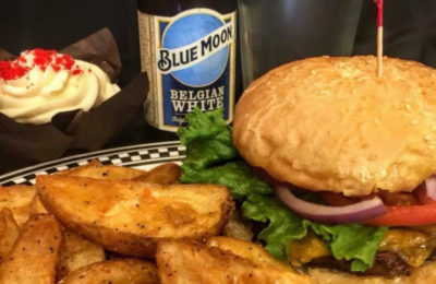 a Burger and fries with Blue Moon beer