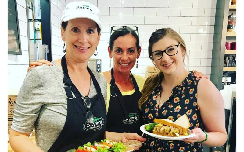 Women holding food at Savory Gourmet