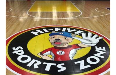 The Hi-Five Sports zone logo on the floor of a basketball court