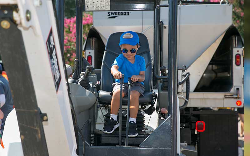 child operating a large machine