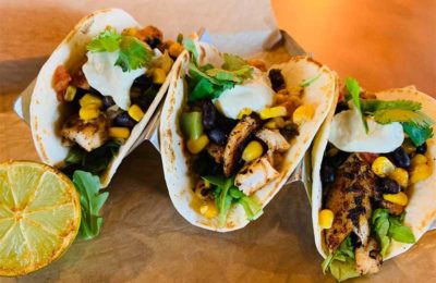 various soft shell tacos with chicken and corn