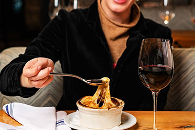 woman eating french onion soup