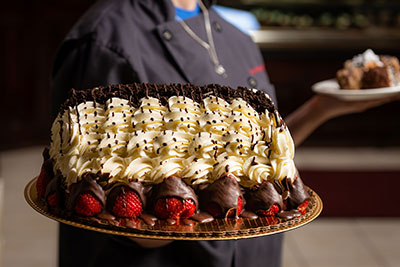 person holding large cake