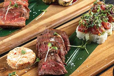 steak and sushi on a cutting board