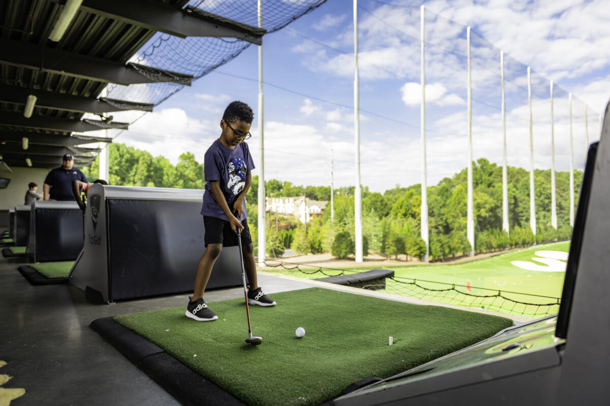 a child golfing