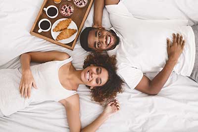 couple on a  bed smiling