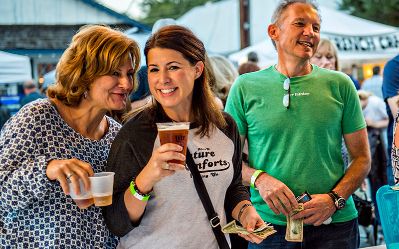 two women holding a beer