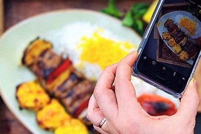 person taking picture of food