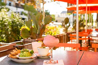 frozen margarita, chips and dip on an outside table