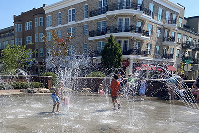 kids playing in water sprayers