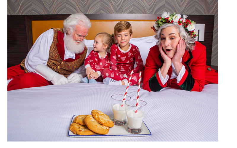santa, mrs. claus with kids on bed for tuckin