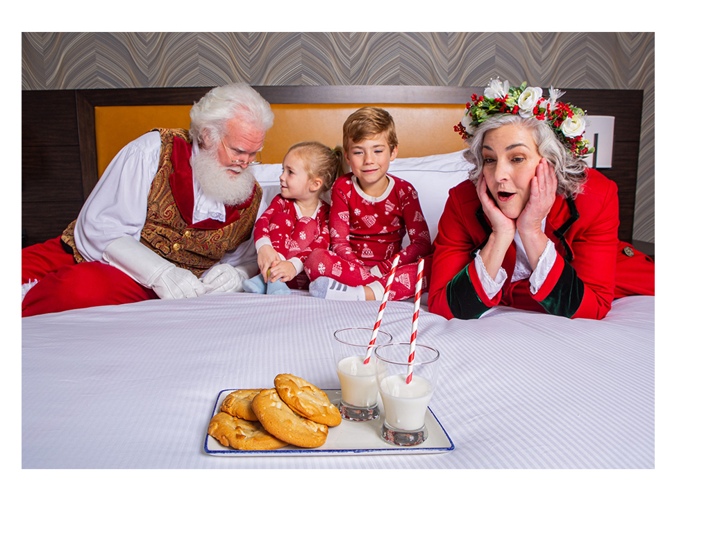 santa, mrs. claus with kids on bed for tuckin