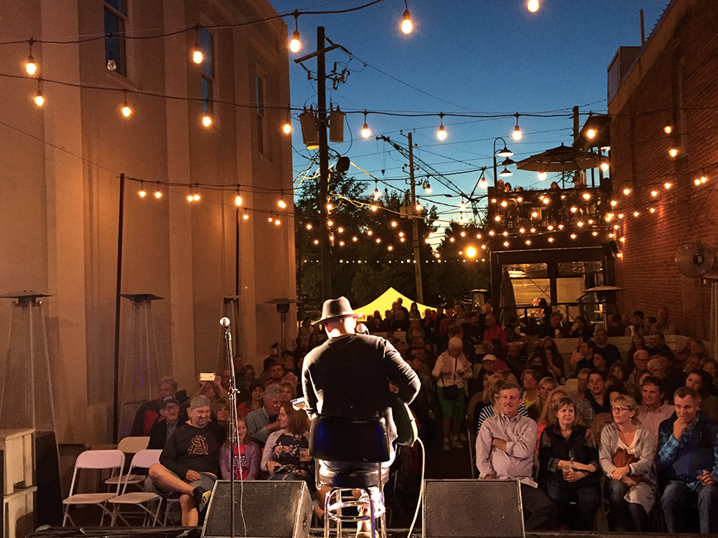 guy playing guitar in front of crowd
