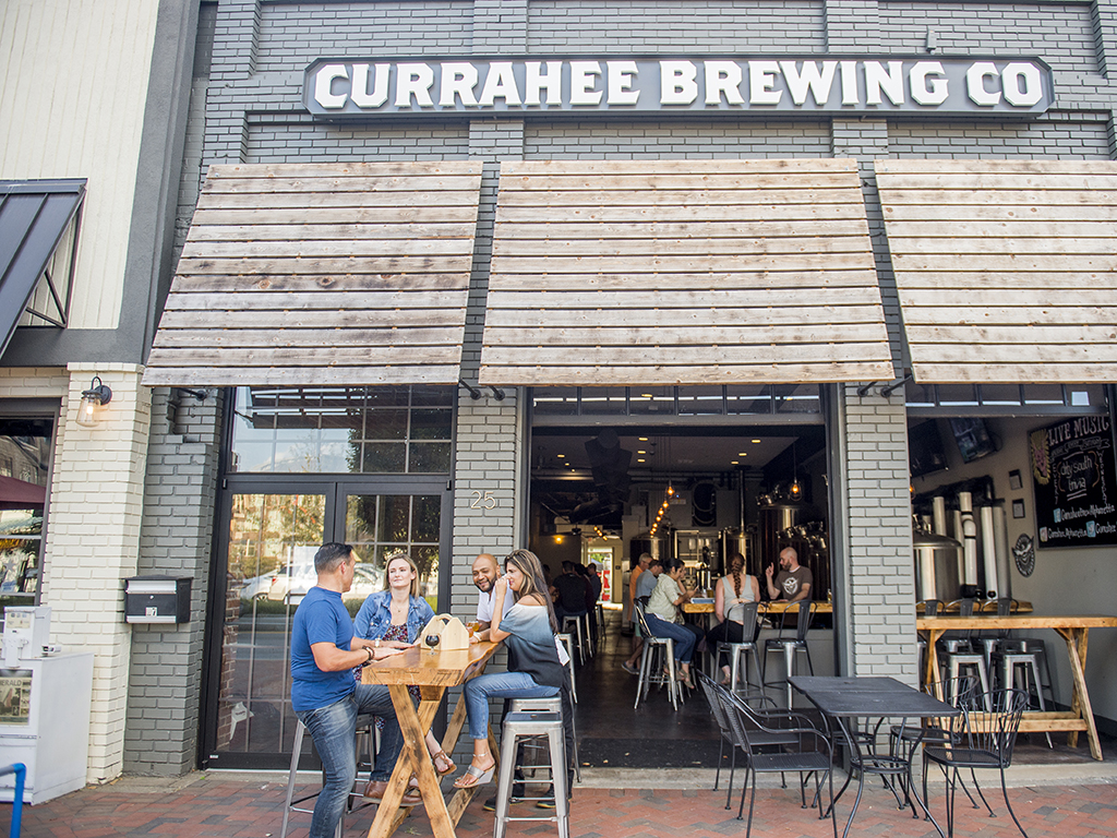 group of people drinking outside brewery