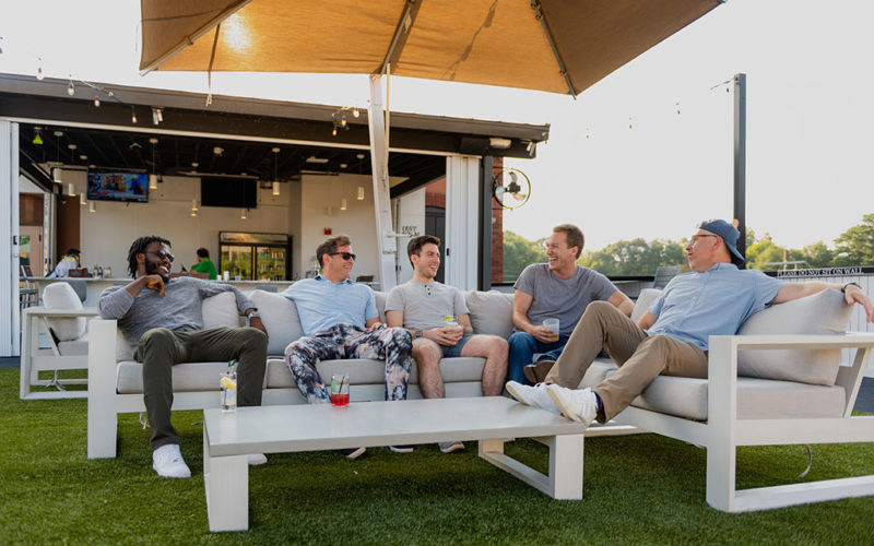 guys sitting on couch outside