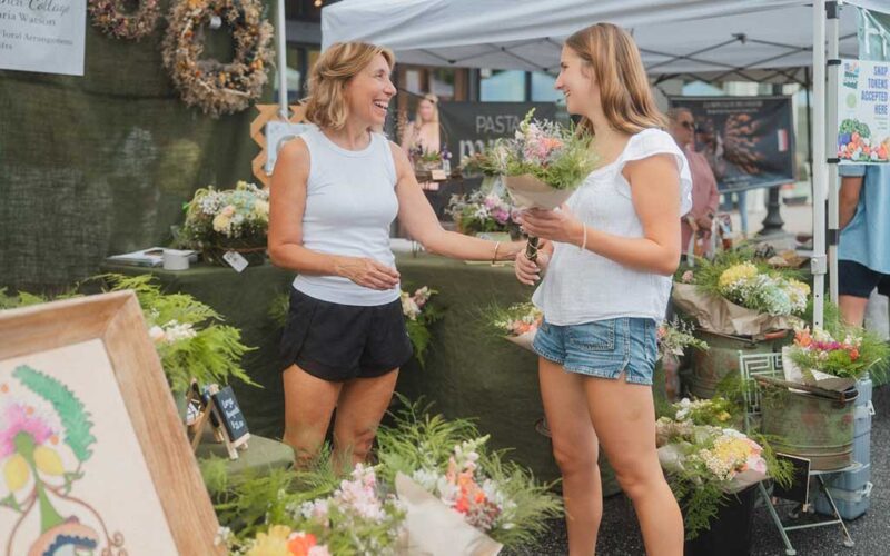 downtown-farmers market-woman-vendor-customer-flowers