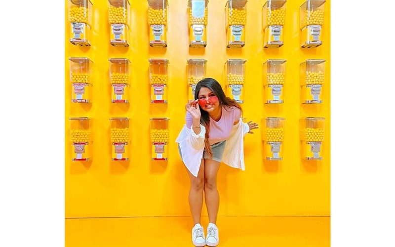 girl standing in front of yellow background