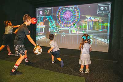 kids playing indoor dodgeball on video game