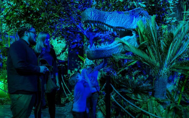 family looking at dinosaur exhibit