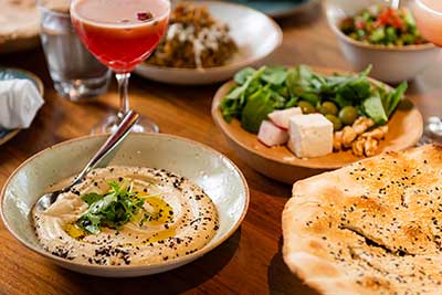 hummus, pita and salad on a table