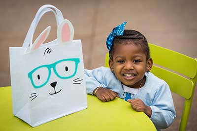 little girl with bunny bag