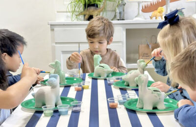 kids decorating dinosaurs with paint