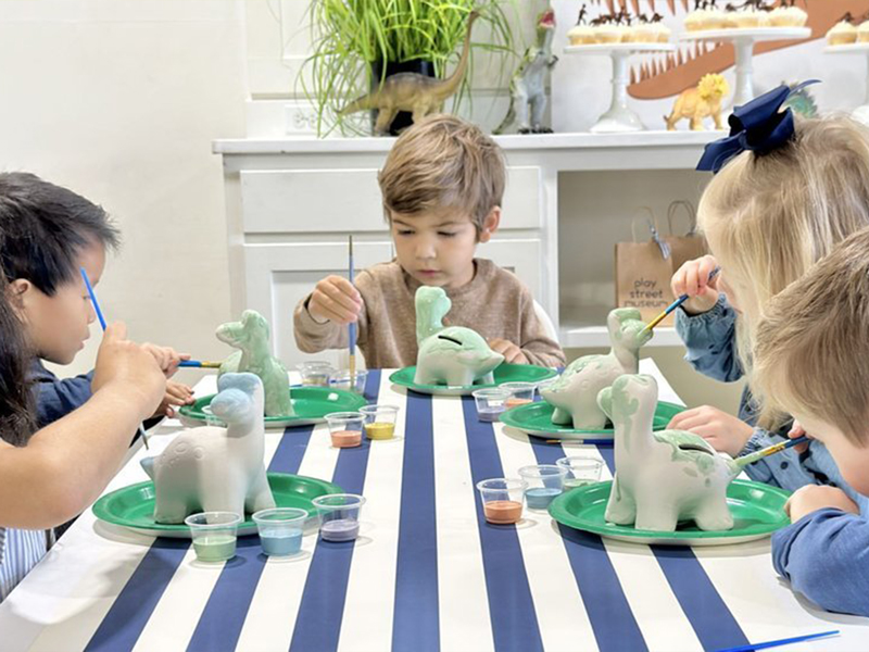 kids decorating dinosaurs with paint