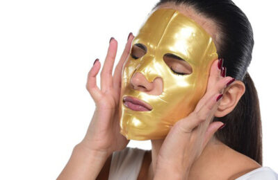Lady doing a gold face mask