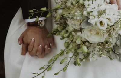 bride and groom holding hands