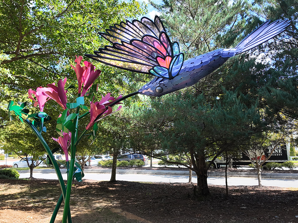 Humming bird sculpture on display in the park.